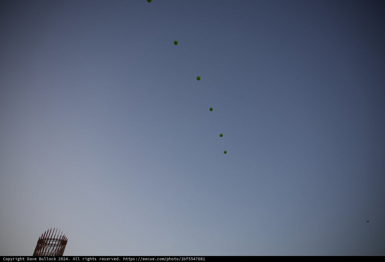 Celestial Dance: Tennis Balls in the Twilight Sky