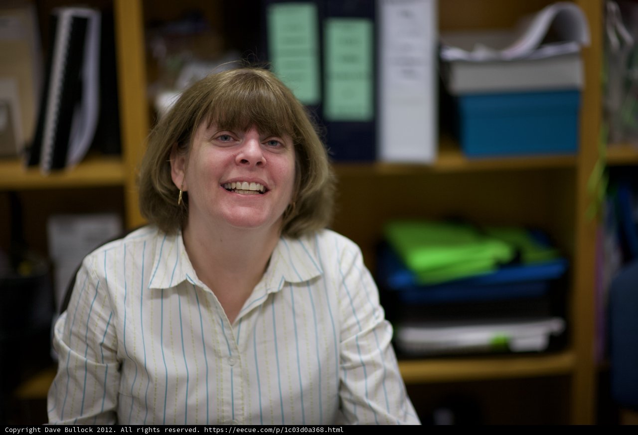 Happy Woman in Front of Bookshelf
