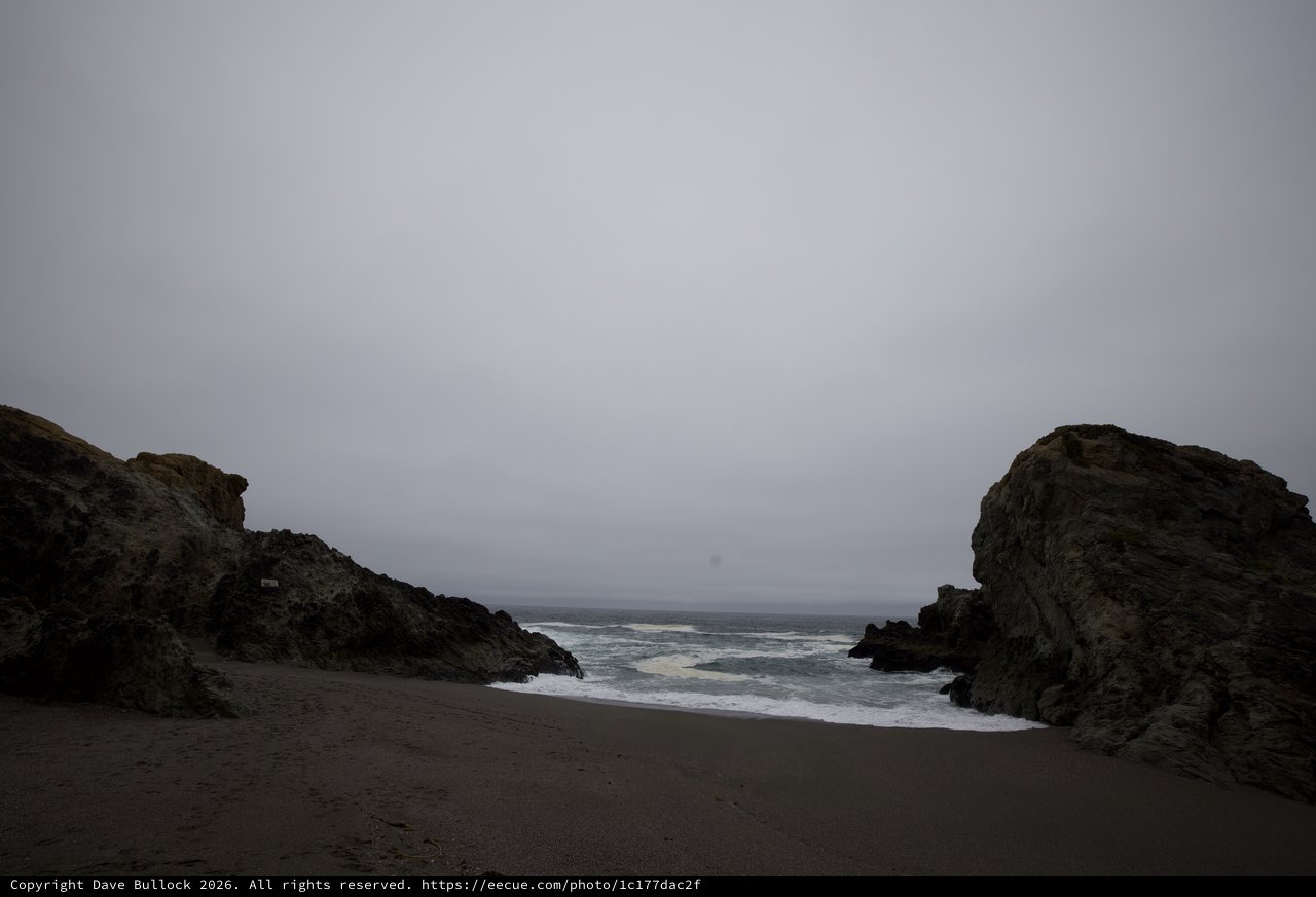 Moody Coastal Cove Between Ancient Rocky Sentinels