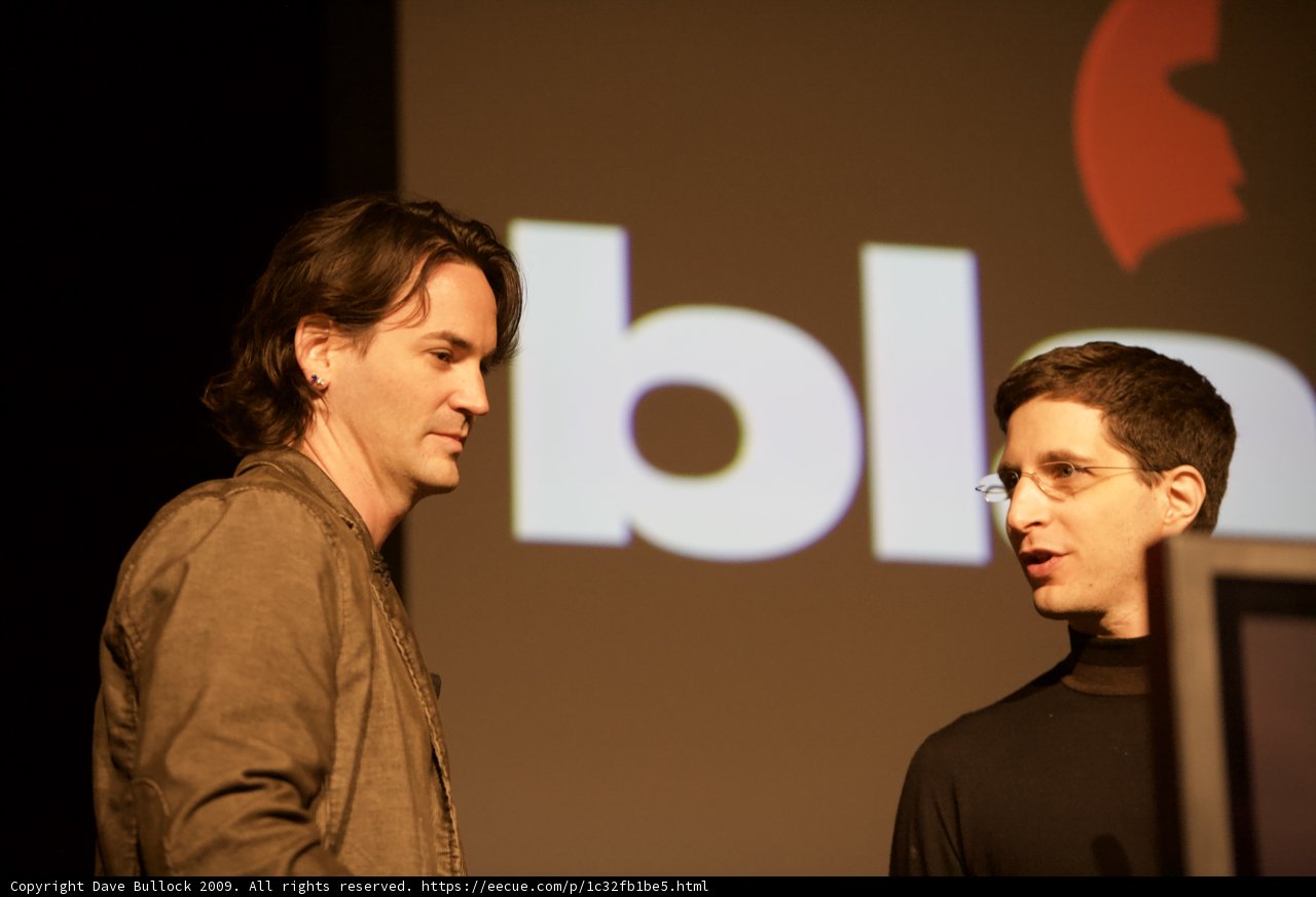 Two Men Presenting in Front of a Screen