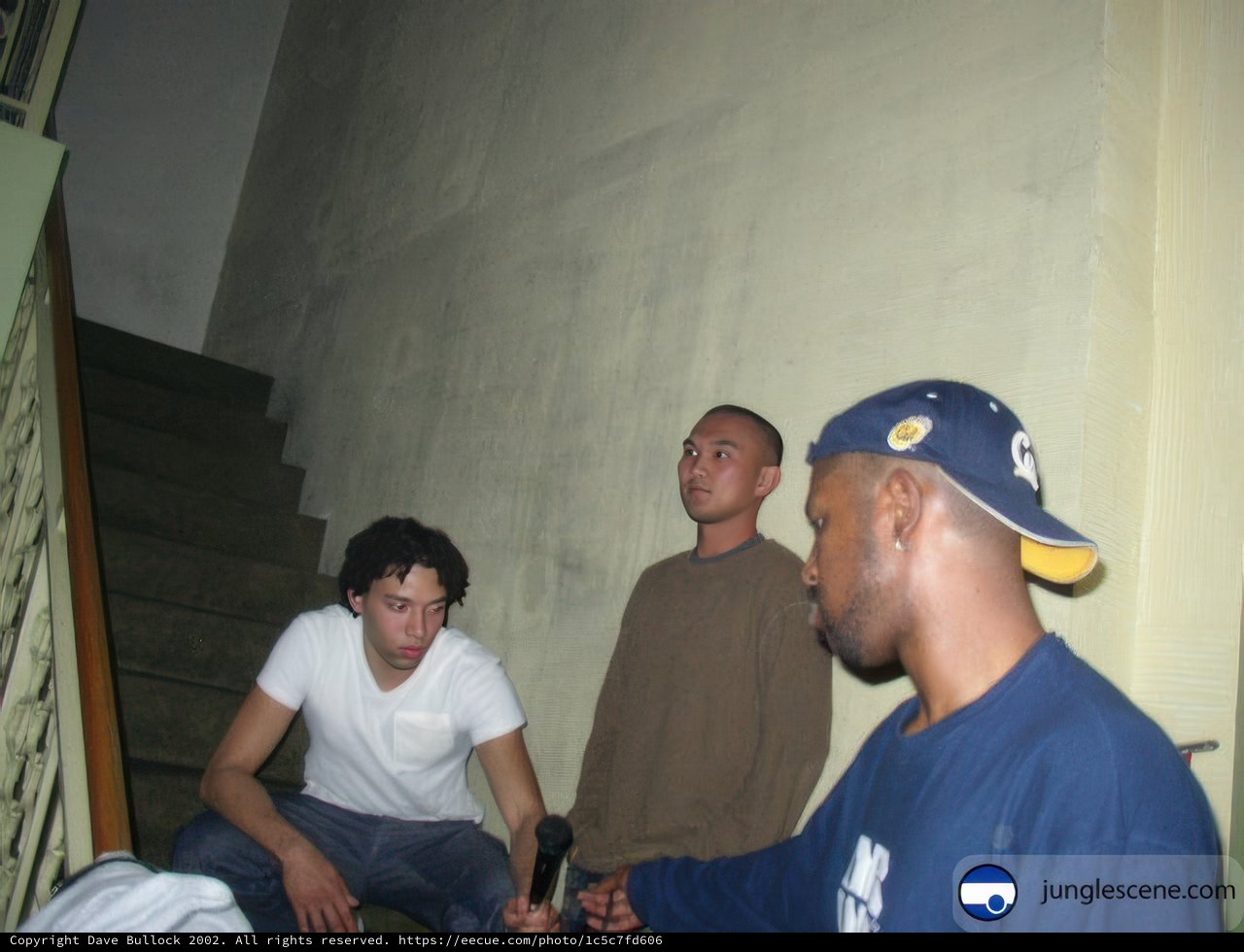 Three Men on Stairs with Cell Phone