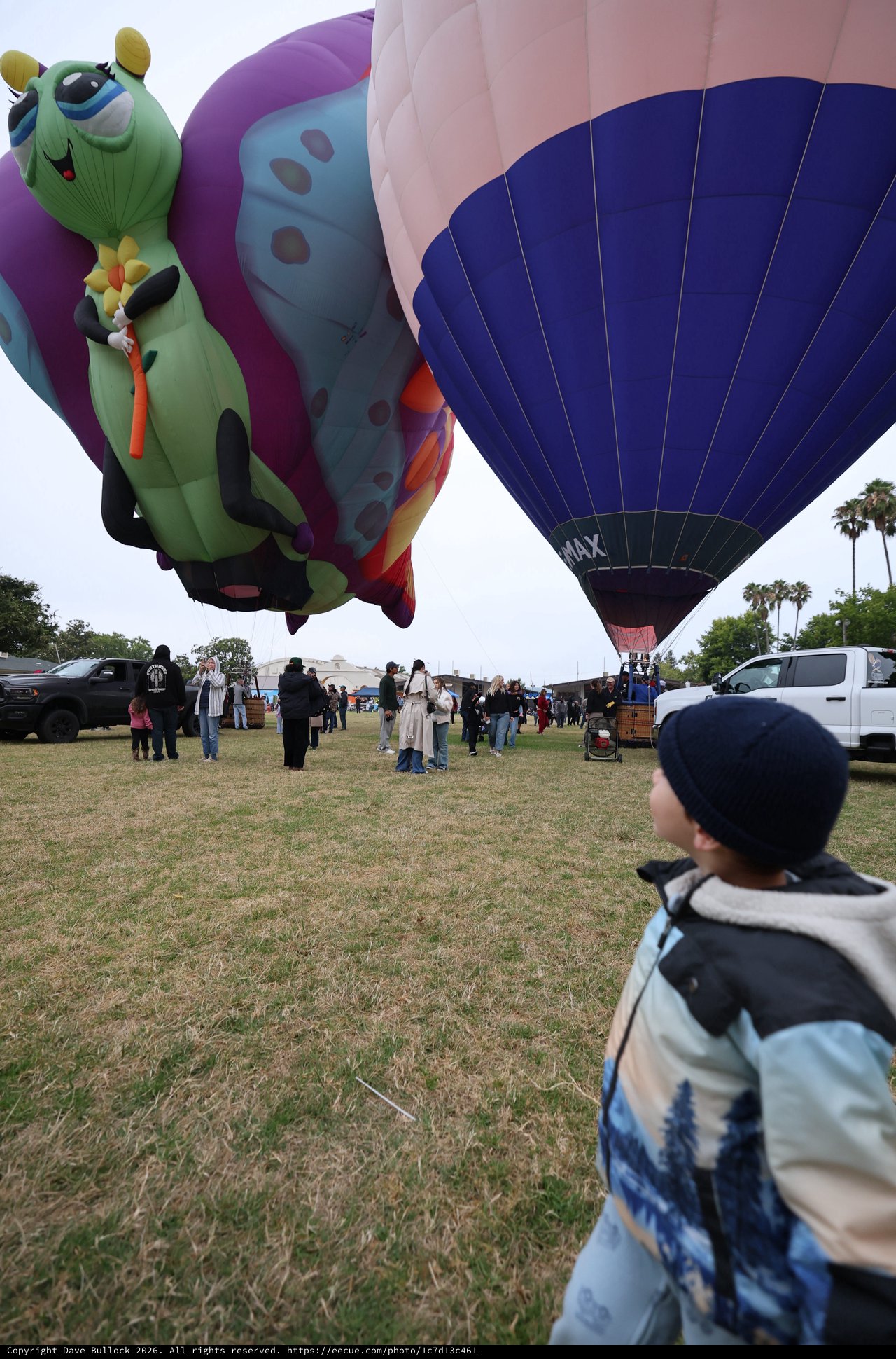 Child Marvels at Giant Caterpillar Hot Air Balloon