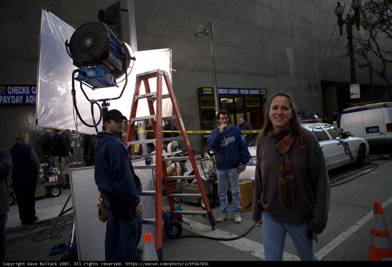 Woman Posing in a Hoodie in Front of a Camera