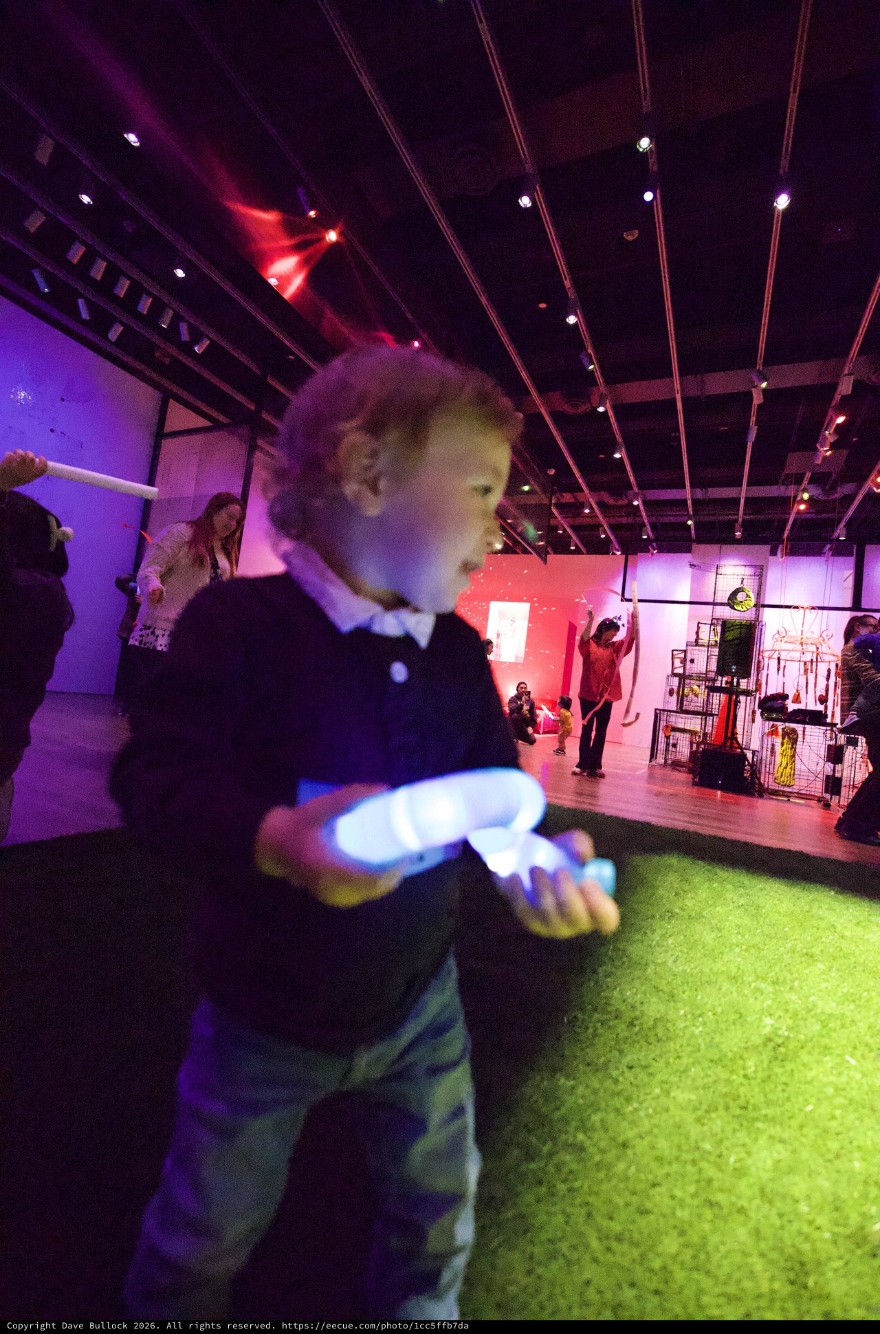 Child Dancing with Glowing Toy at Baby Rave Event