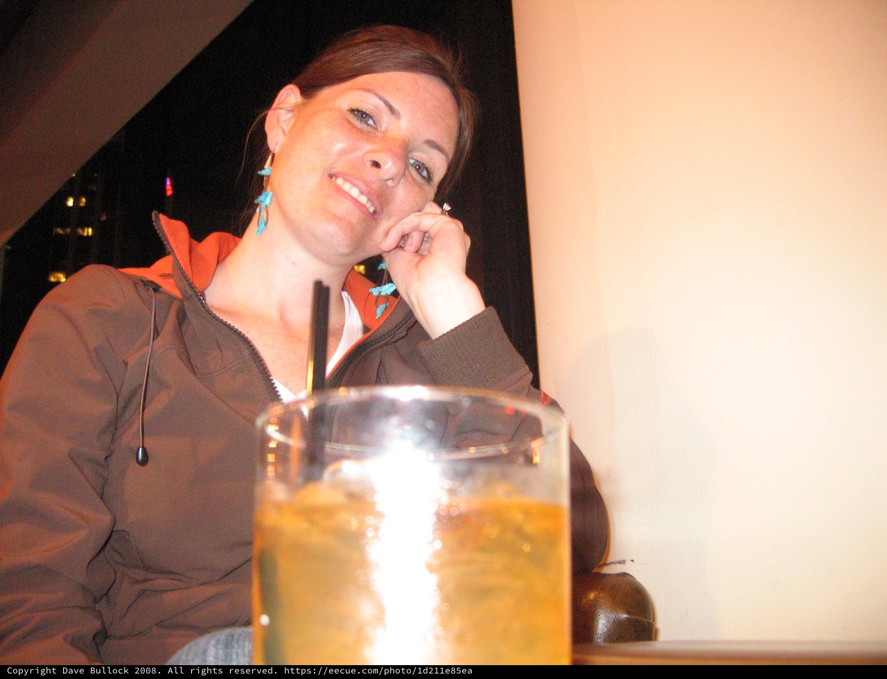 Smiling Woman Relaxing with Drinks After Hike