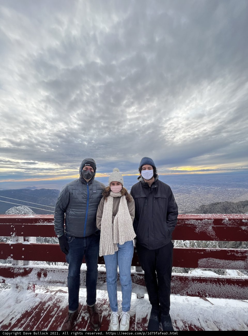 Snowy Deck View with Three People