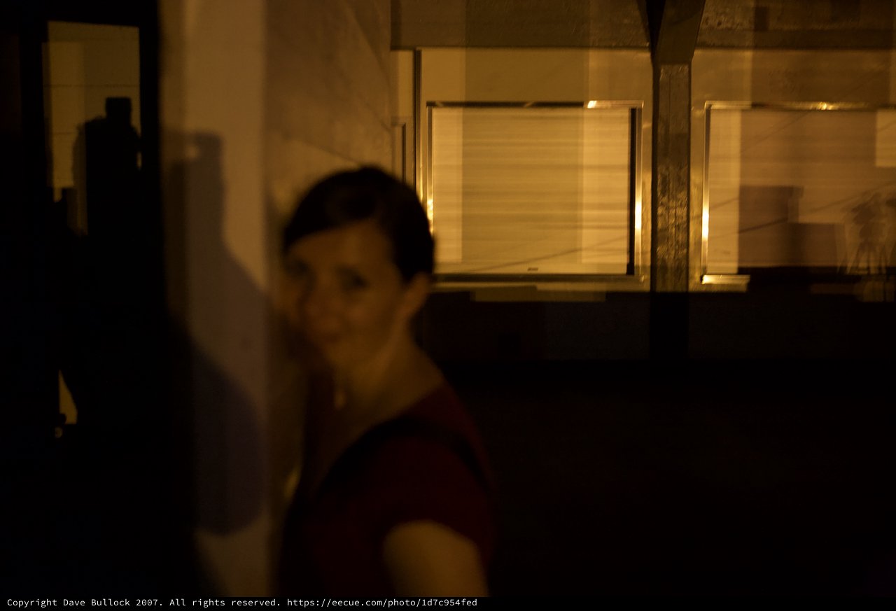 Mysterious Woman Emerges from Shadows at Night
