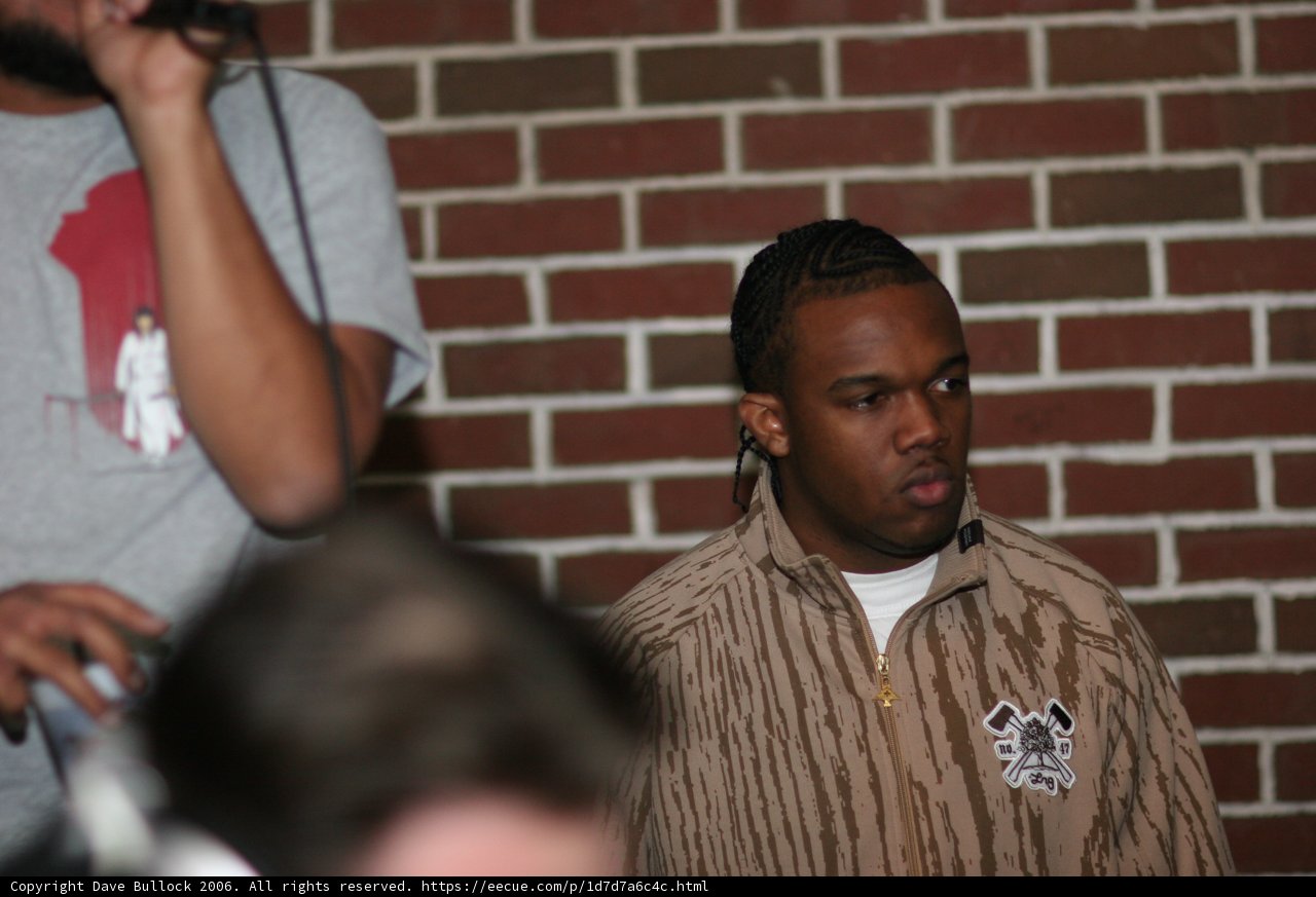 Brown Jacket Man with a Microphone