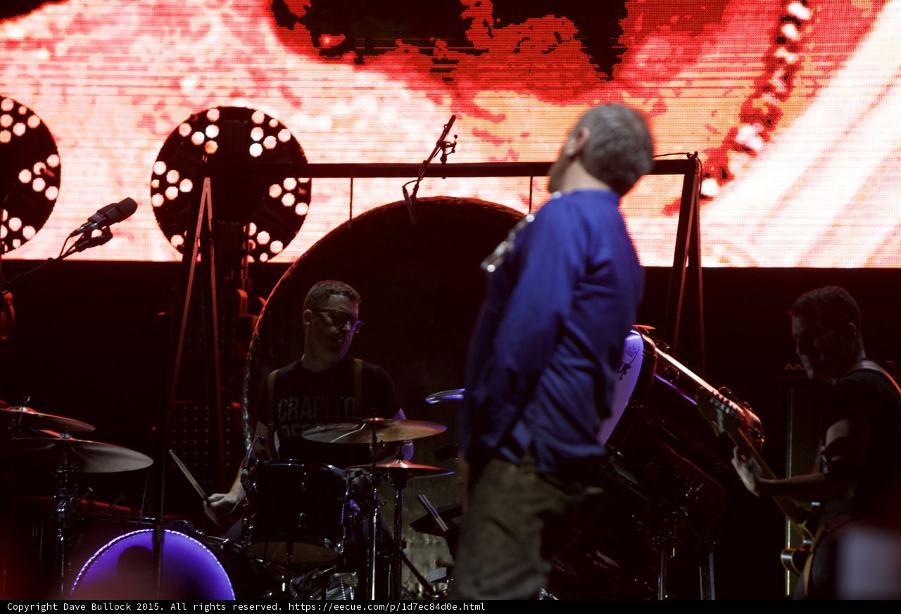 Morrissey From Behind Blue Shirt Drummer Glasses Capitol Tee Bassist Two Circular Lights Red Screen