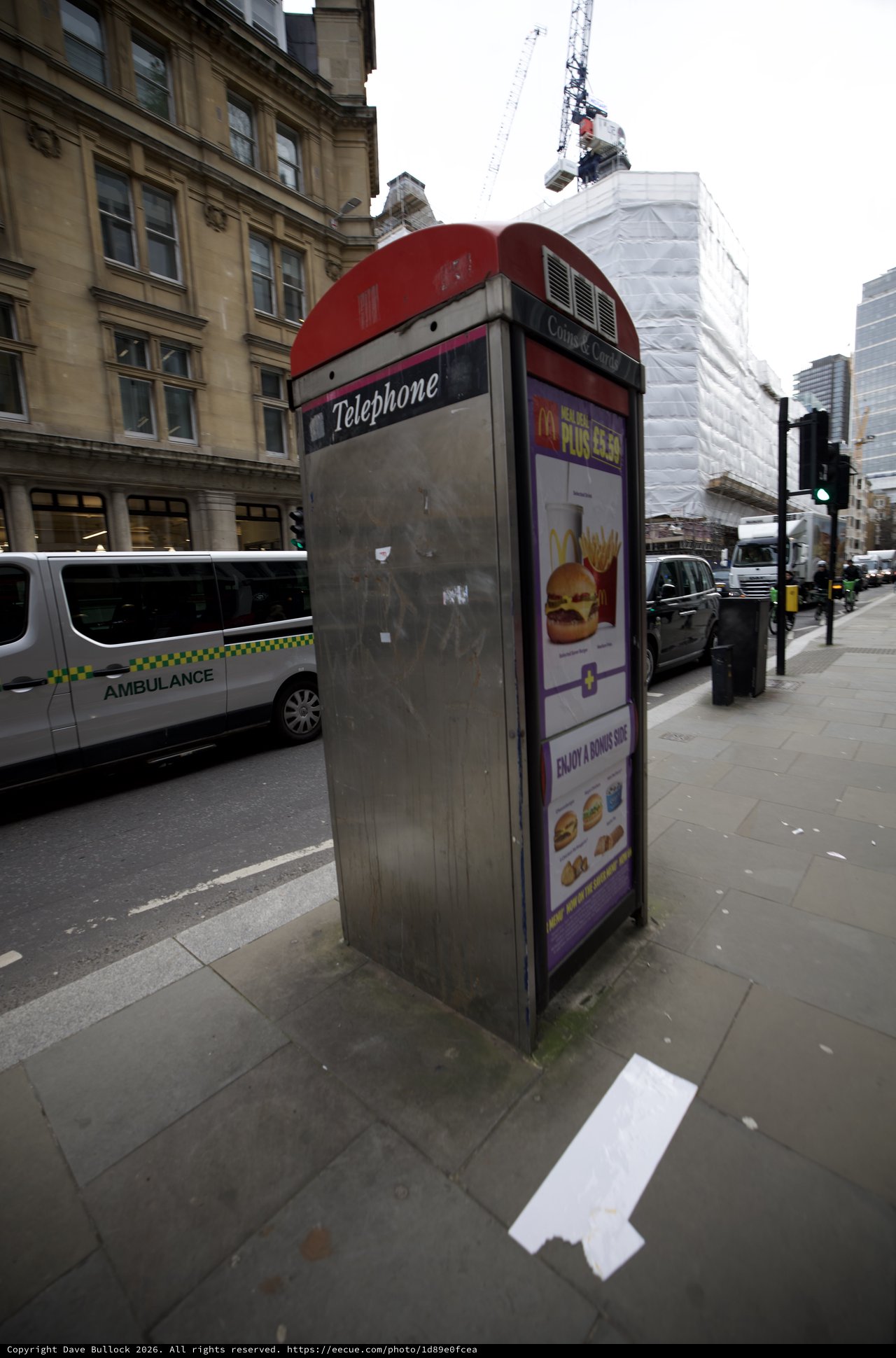 Traditional Red Telephone Box with McDonald's Advertisement in London