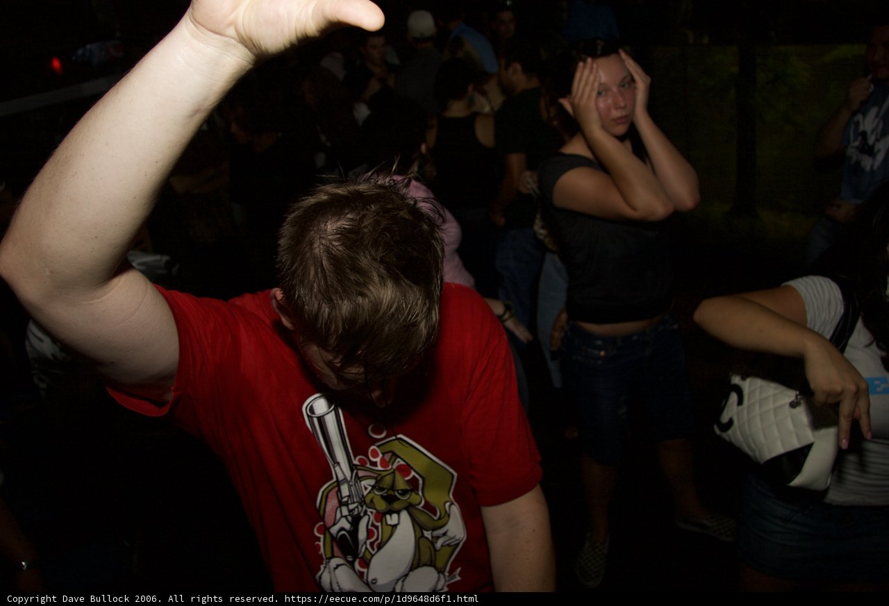 Red Shirted Man Dancing in Nightclub Crowd