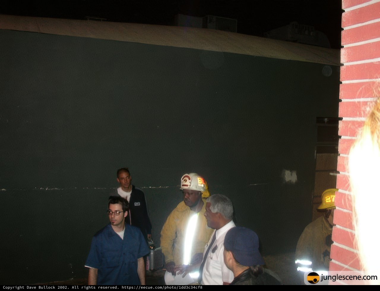 Firefighters and Officials Gather Around Fire Truck