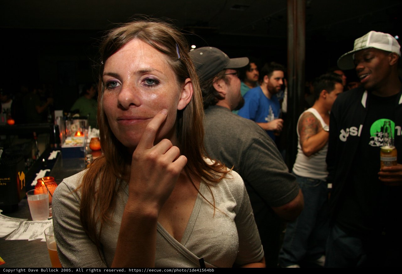 Thoughtful Woman Posing at Crowded Nightclub Bar