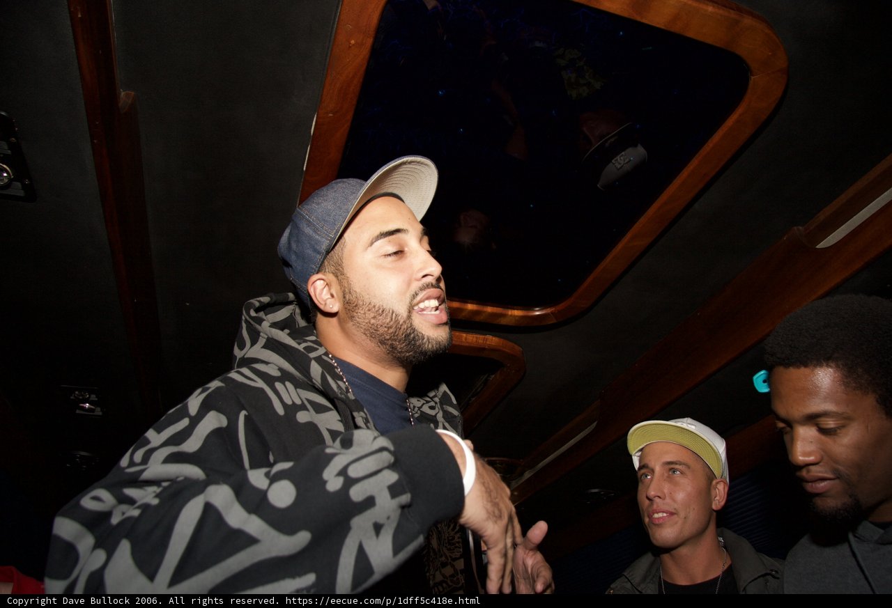 Two Men in Hats Engage in Conversation