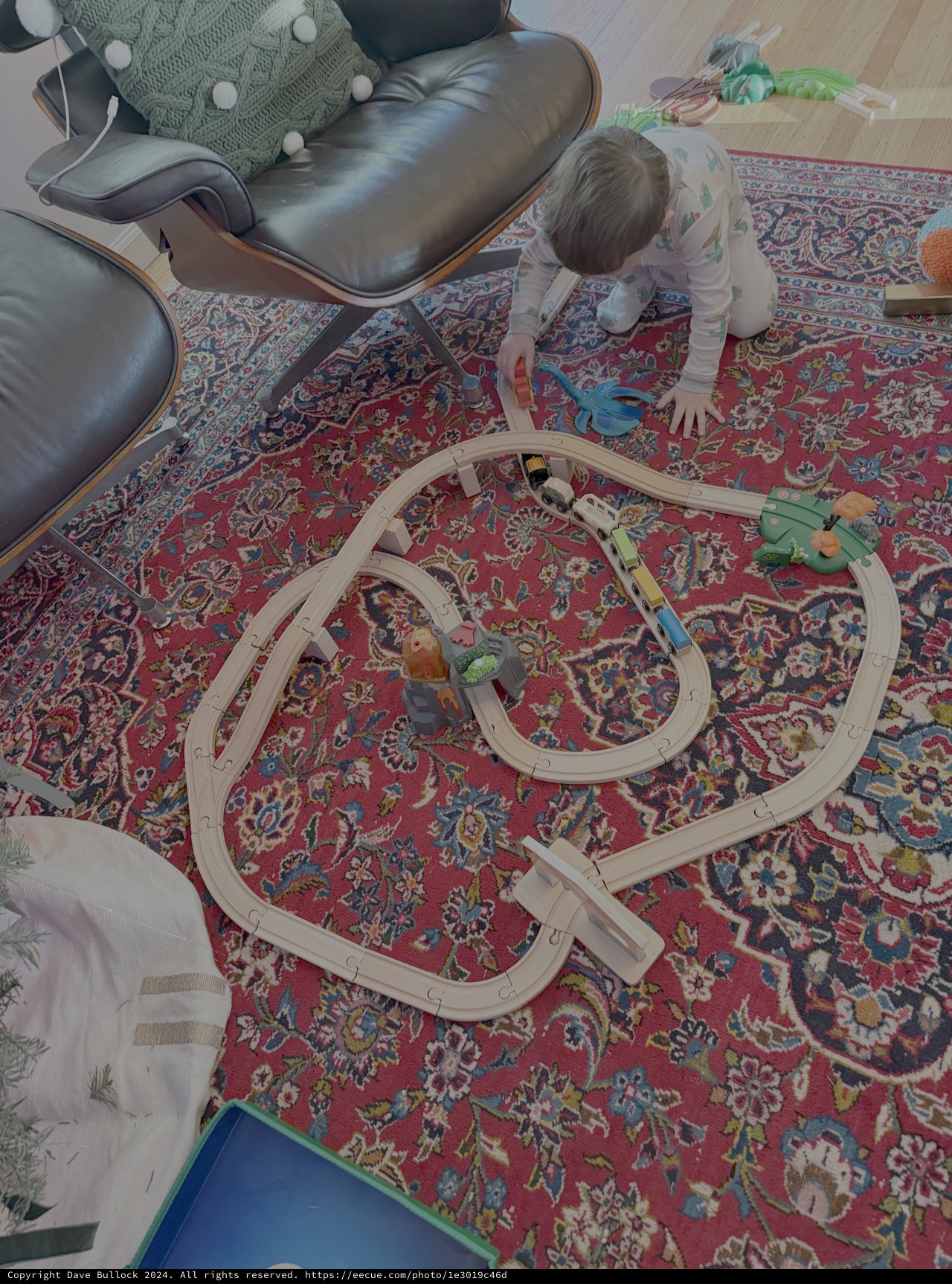 Child Playing with Train Set on Persian Rug