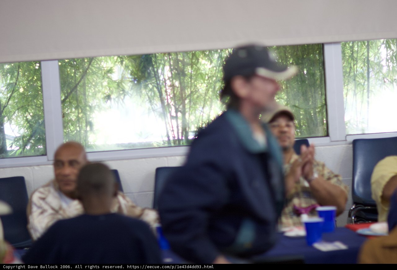 Man in Baseball Cap Enjoying a Meal at a Restaurant