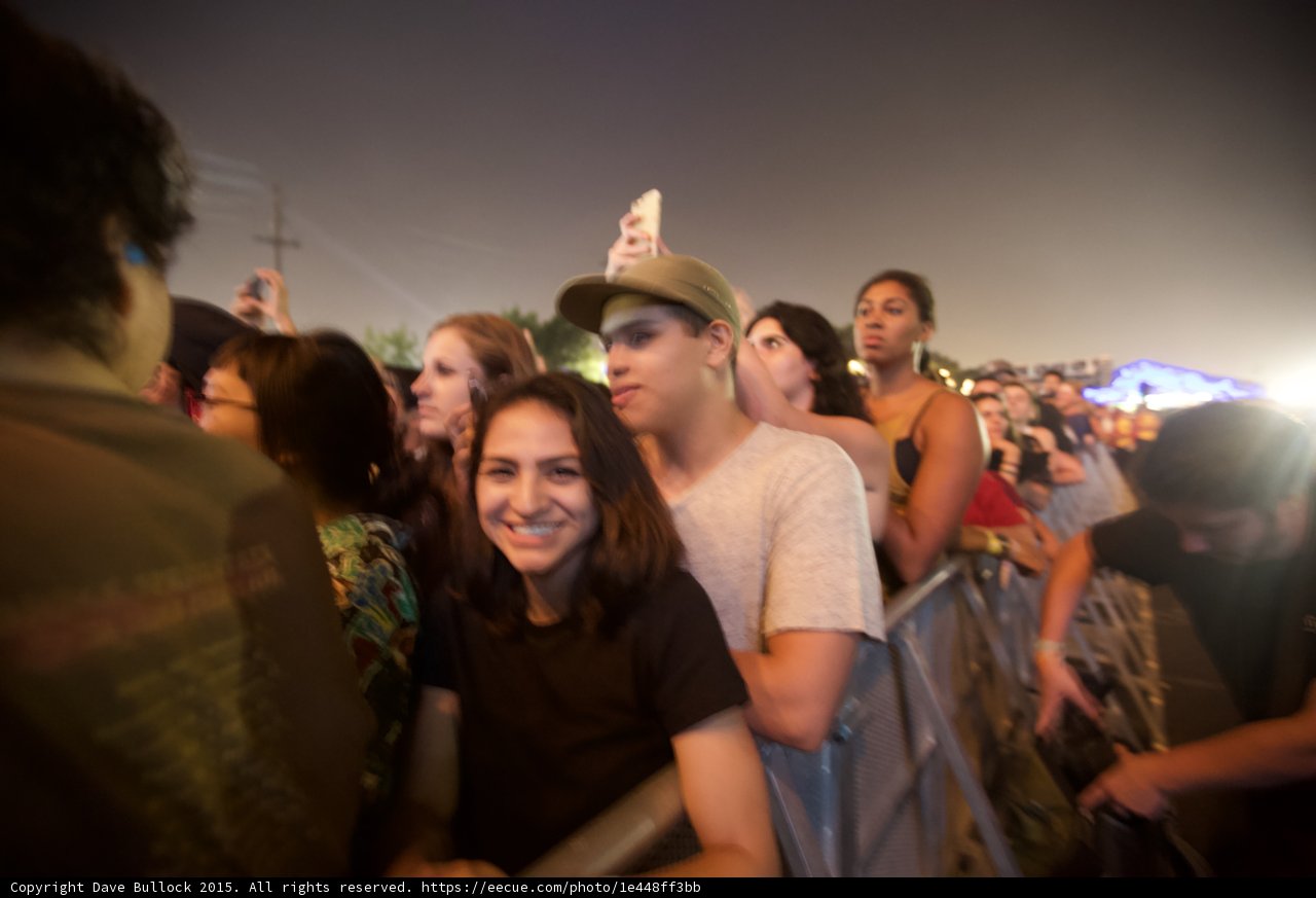 Smiling Woman in Crowd