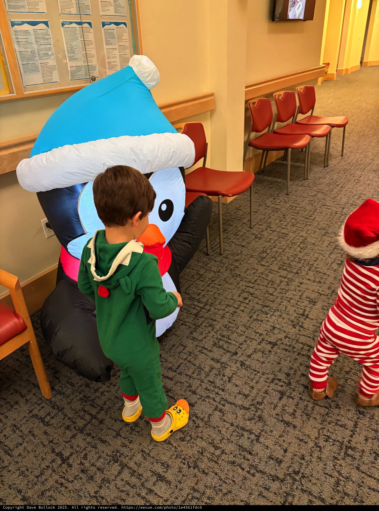 Child Hugging Inflatable Snowman Character in Waiting Room