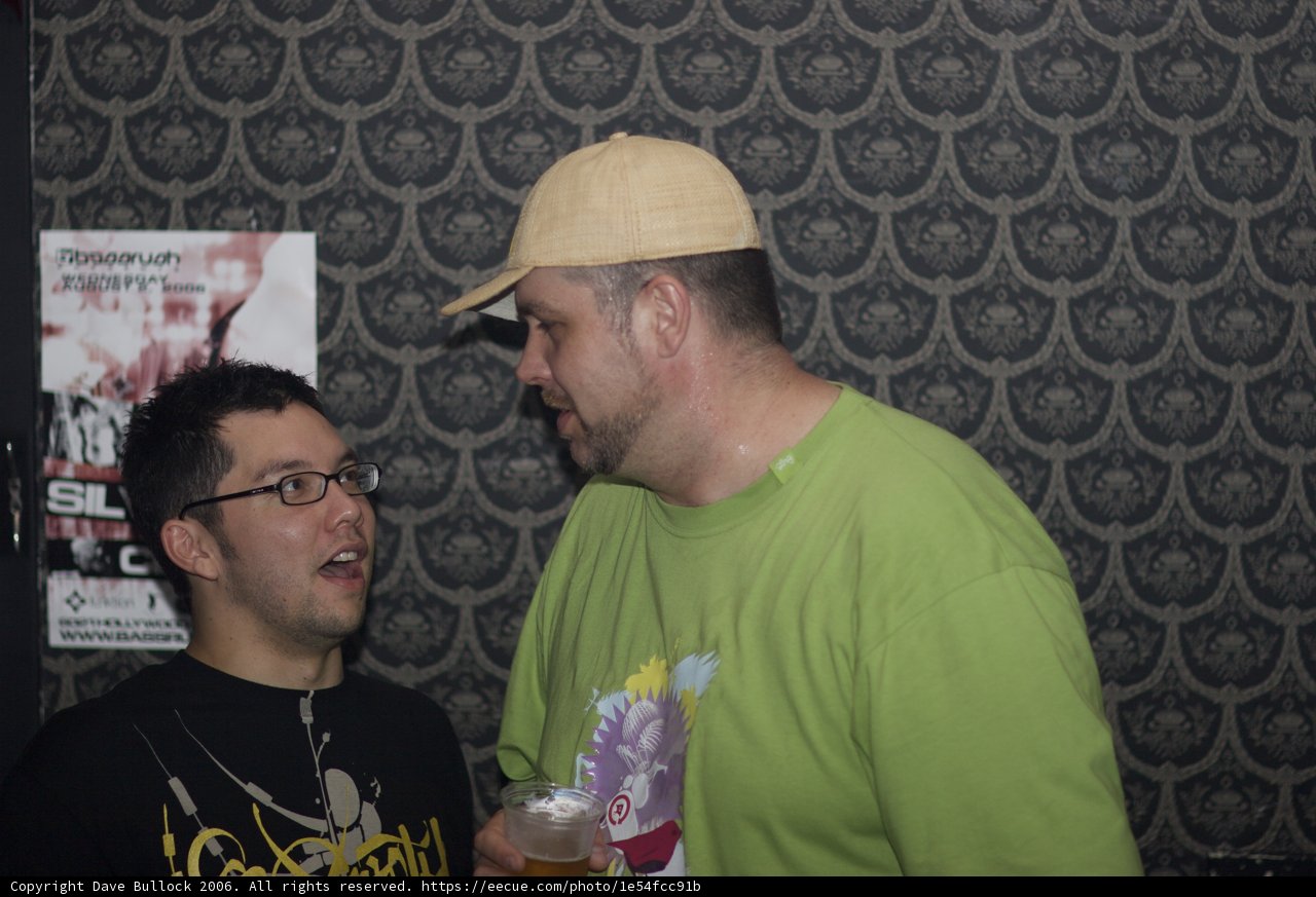 Two Men Chatting Over Drinks