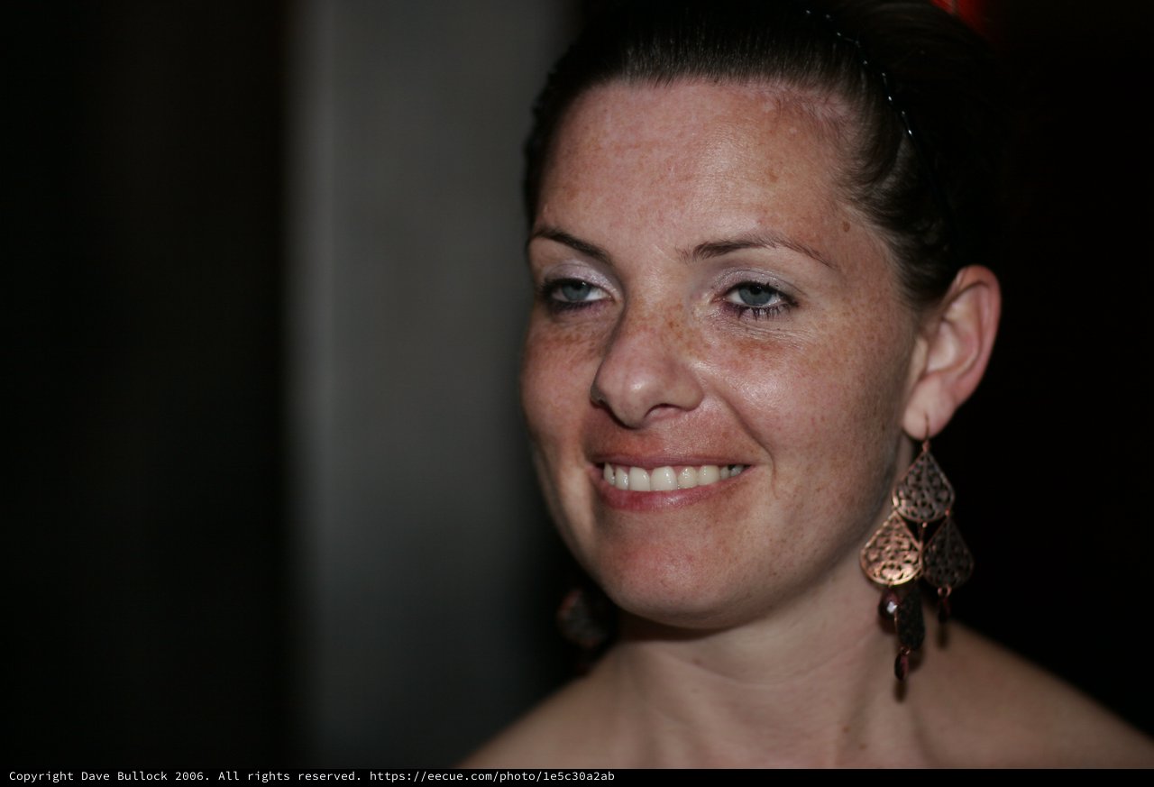 Radiant Smile: Freckled Woman in Warm Portrait