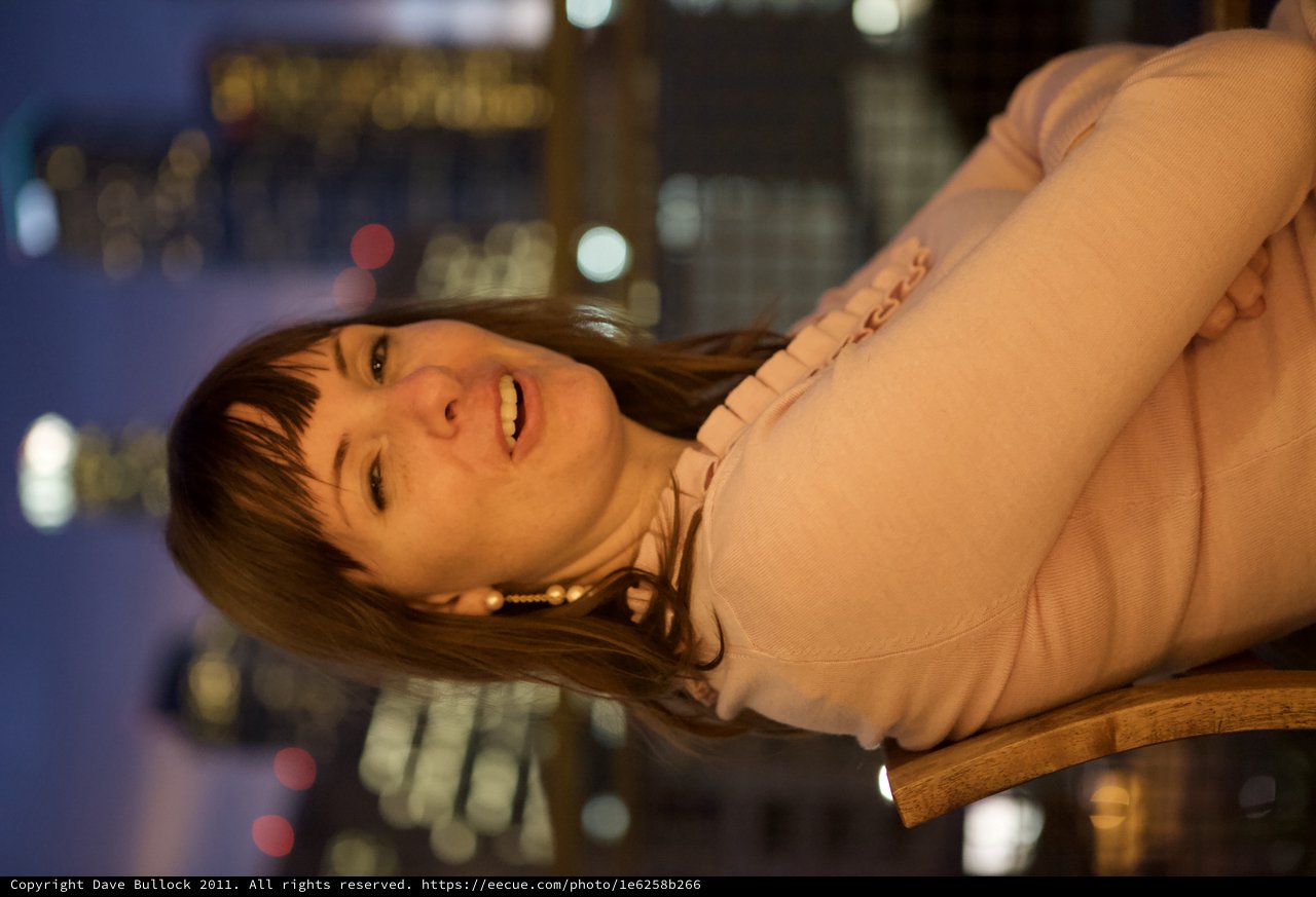 Penelope Smiling Against a City Nightscape