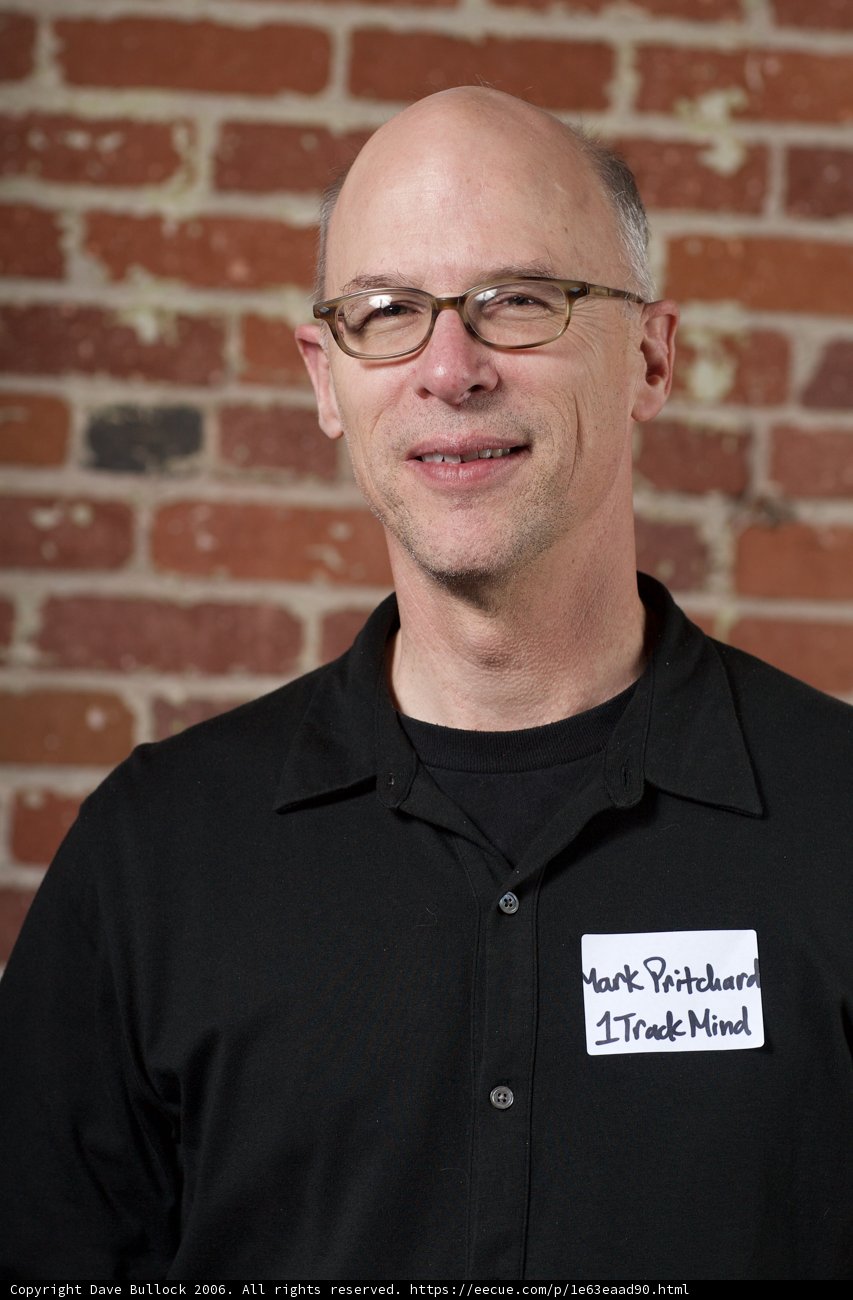 Bald Man with Glasses and Black Shirt