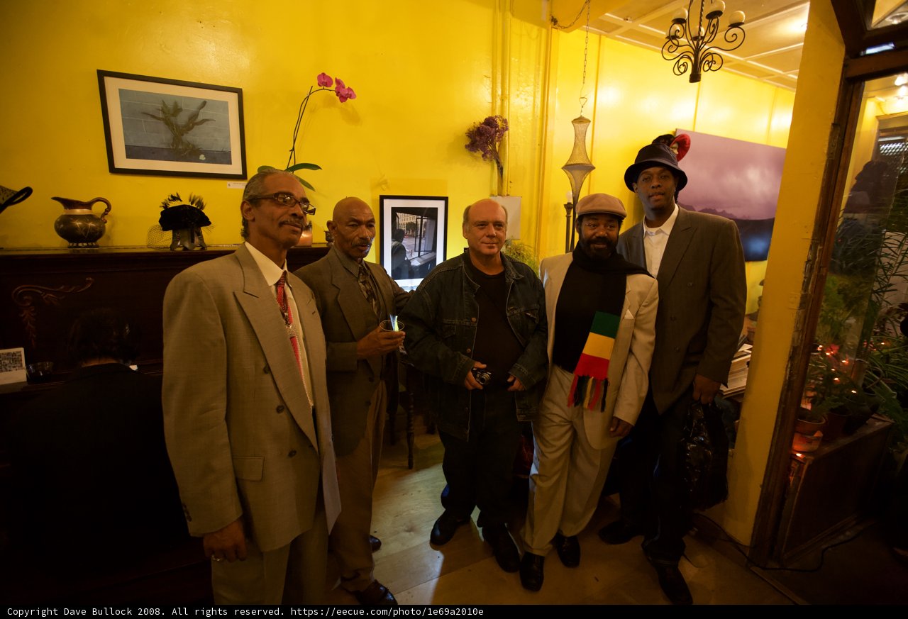 Men in Formal Attire Posing in front of Yellow Wall