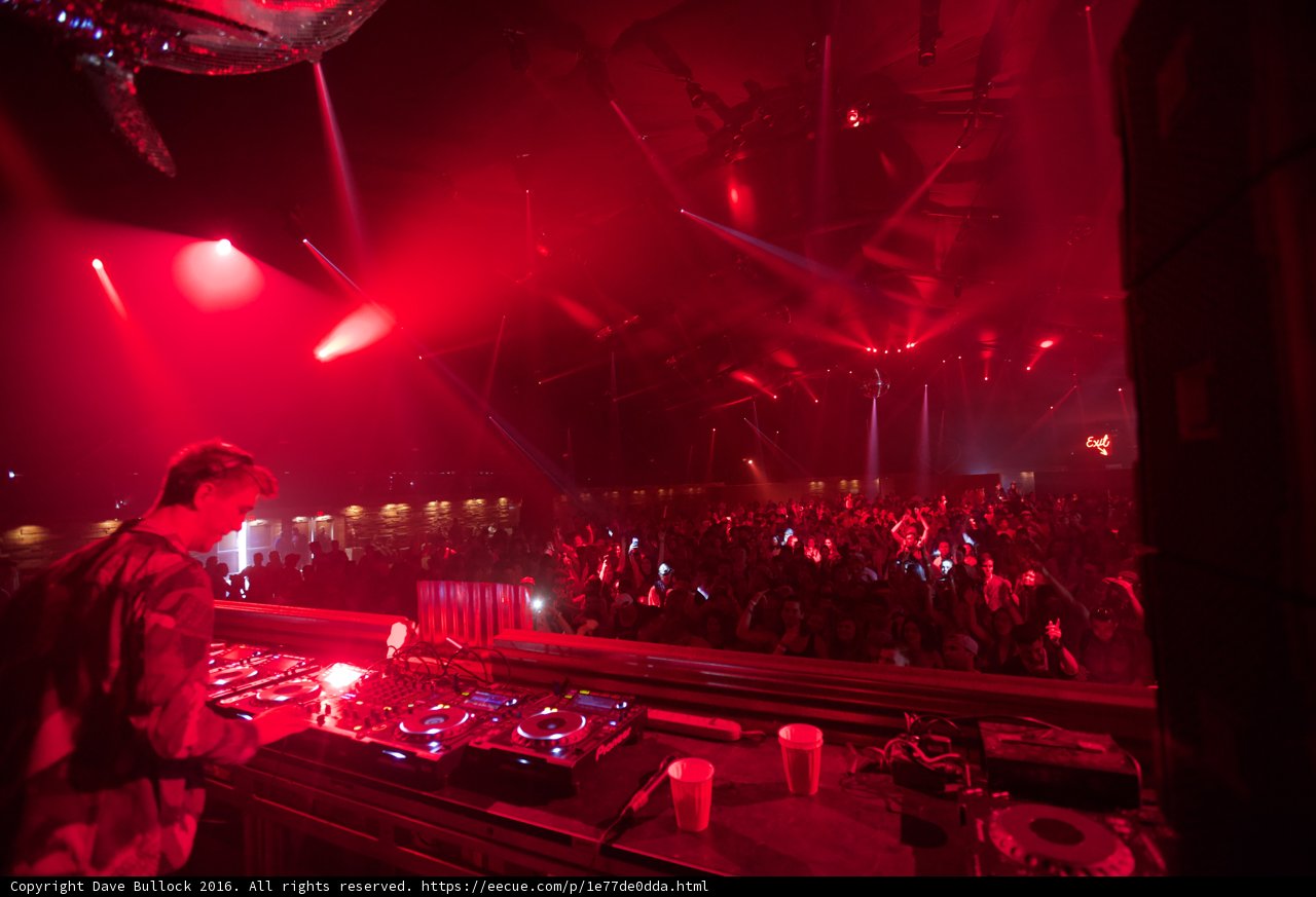 Red-Lit Concert with DJ and Crowd