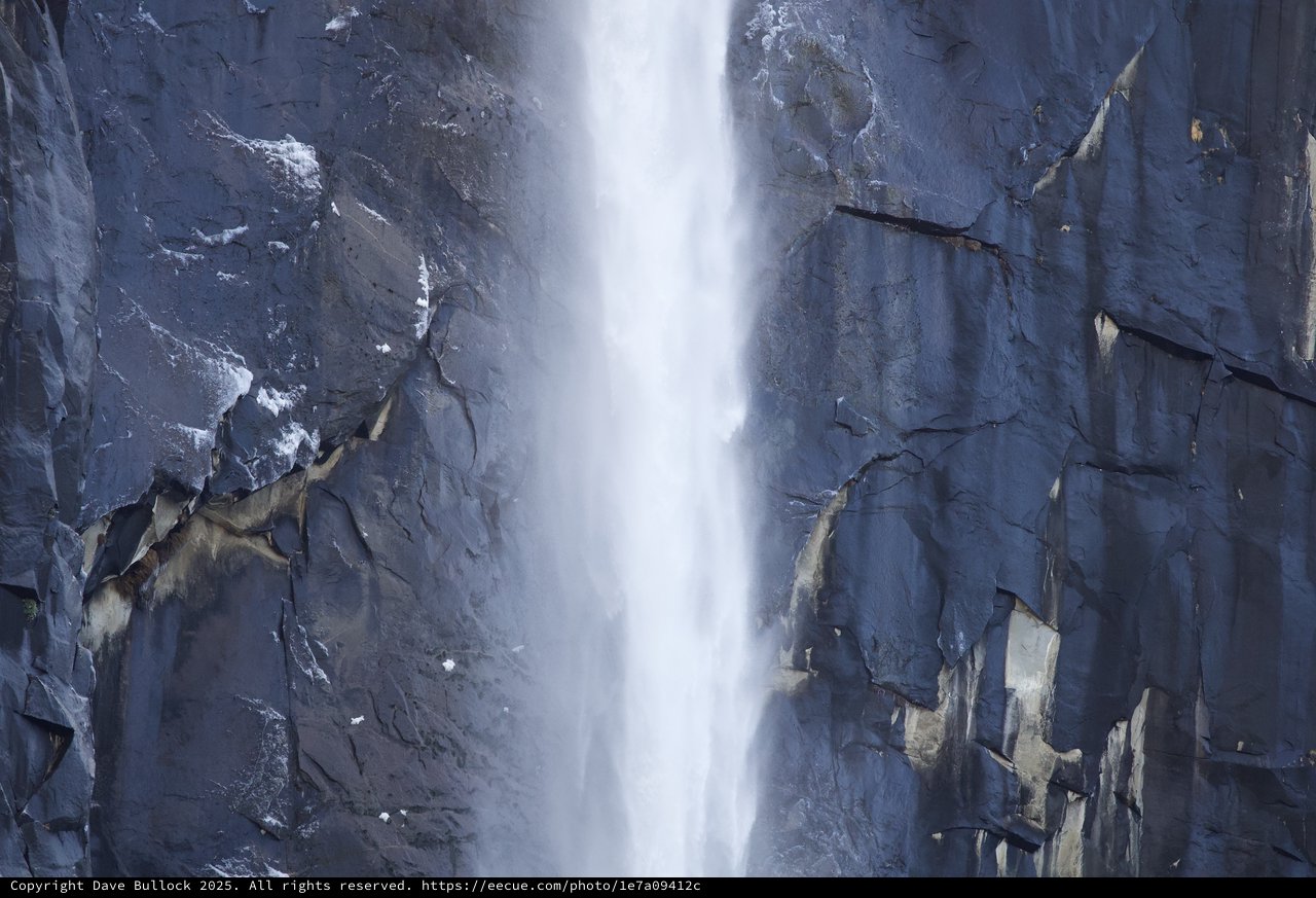 Cascading Waterfall Through Dramatic Granite Cliffs in Winter