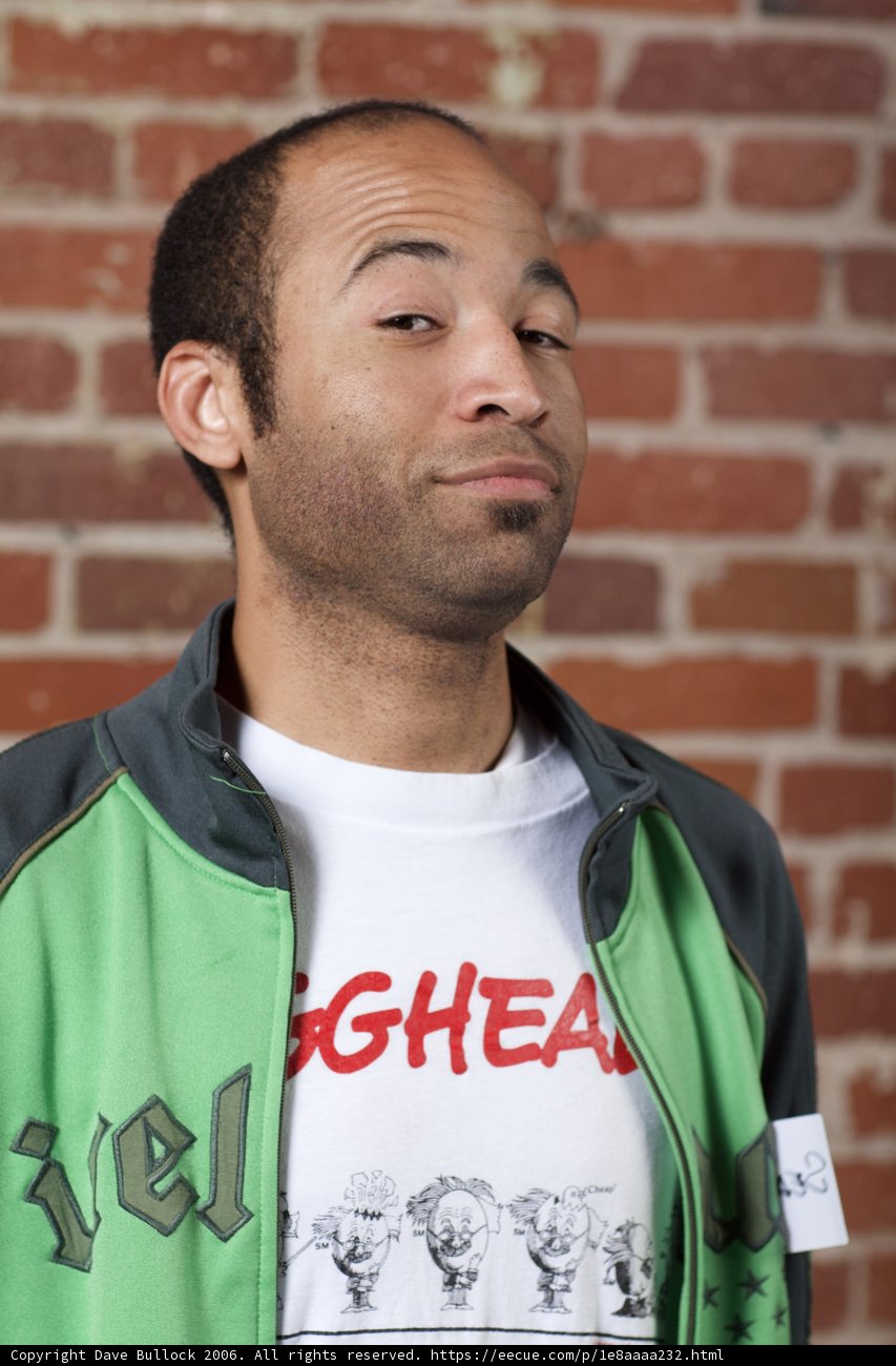 Man in Green Jacket and White T-Shirt