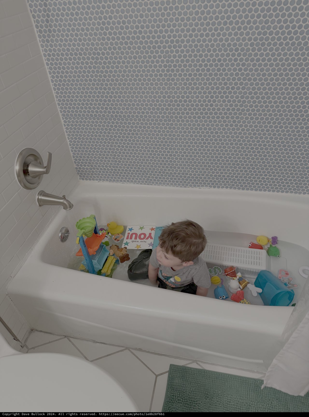 Toddler Playing with Toys in Bathtub