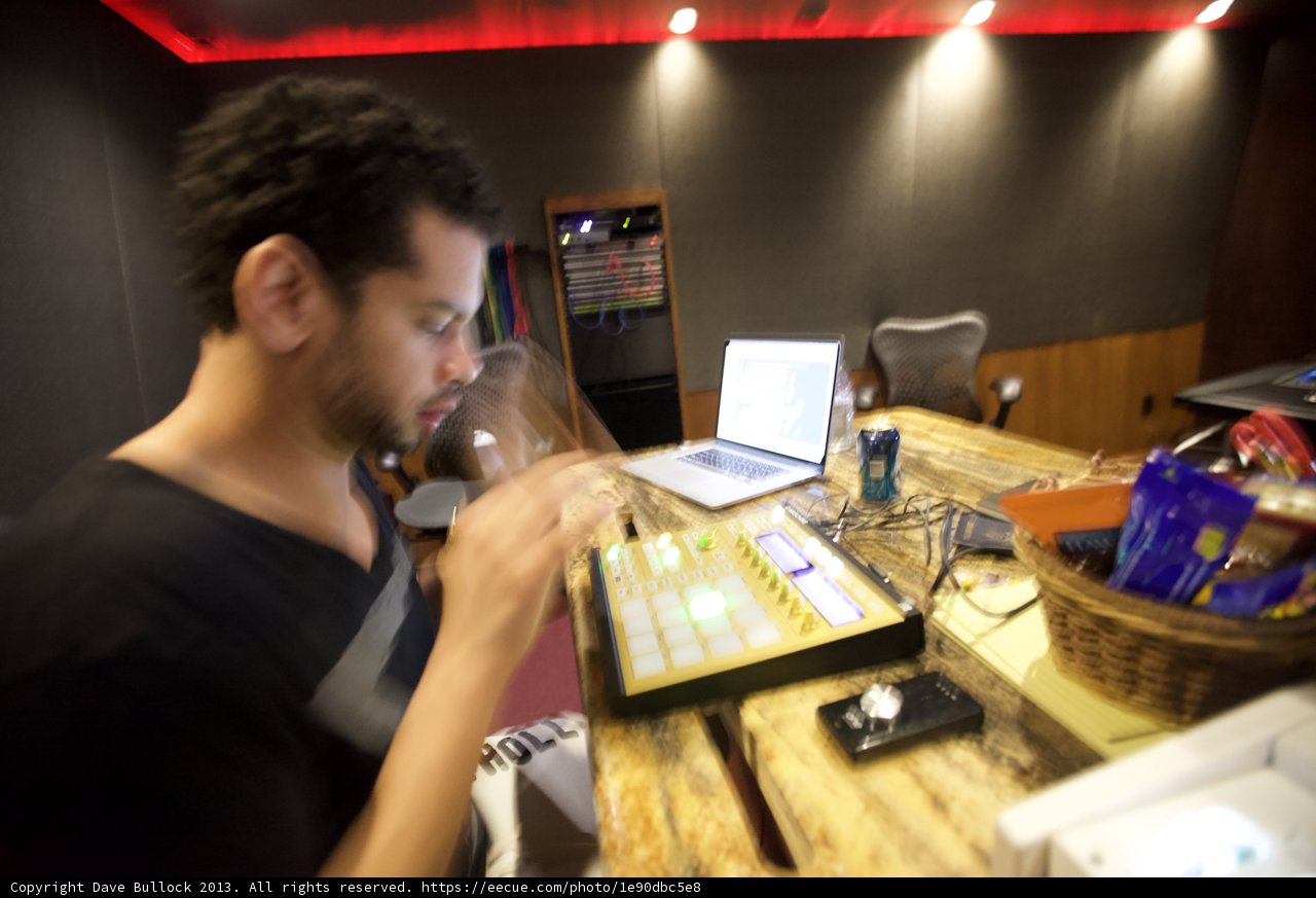 Man at Table with Laptop and Microphone