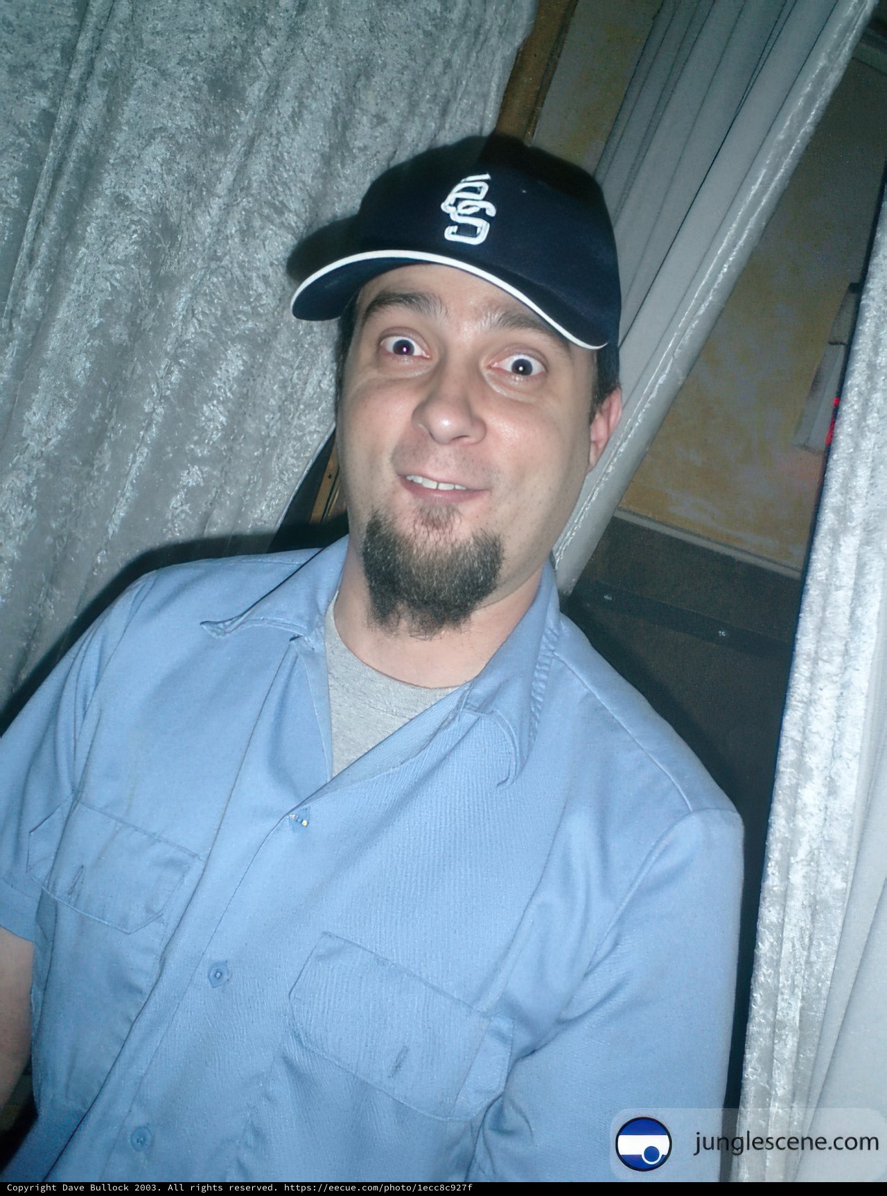 Blue-Shirted Man with Baseball Cap