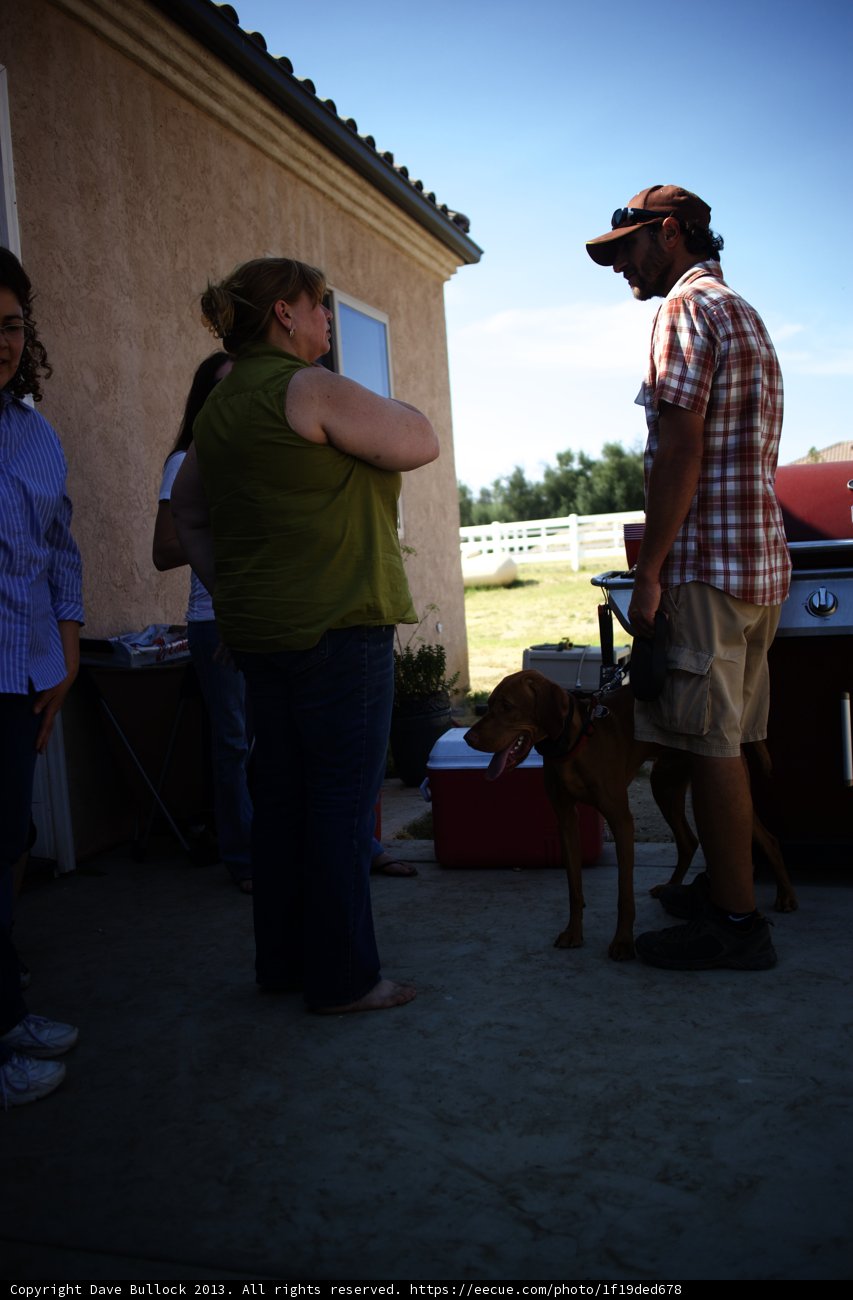 Man and Woman Pose with Their Canine Companion