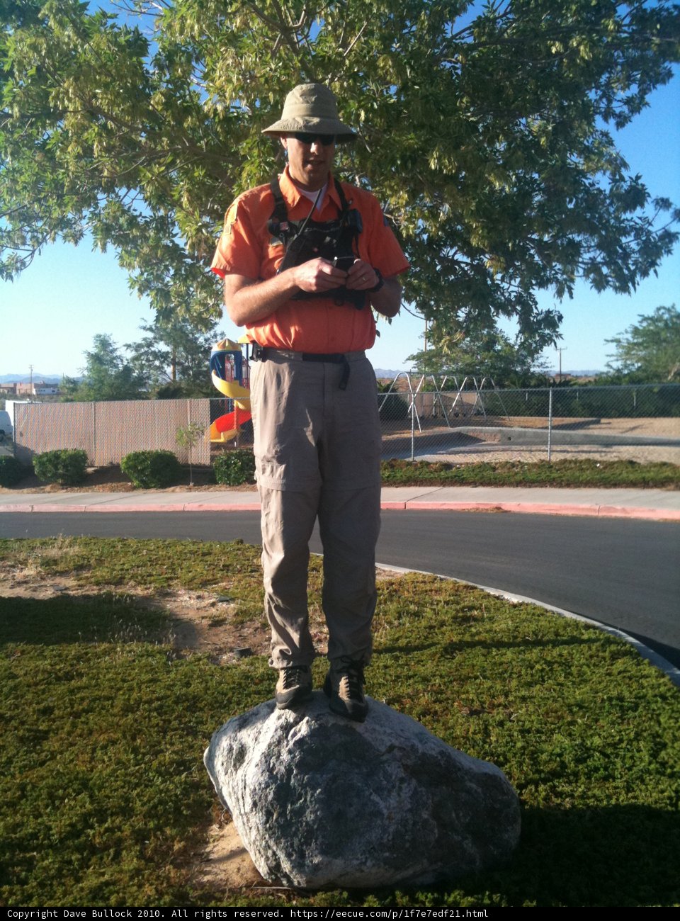 Man Standing on Rock Talking on Phone