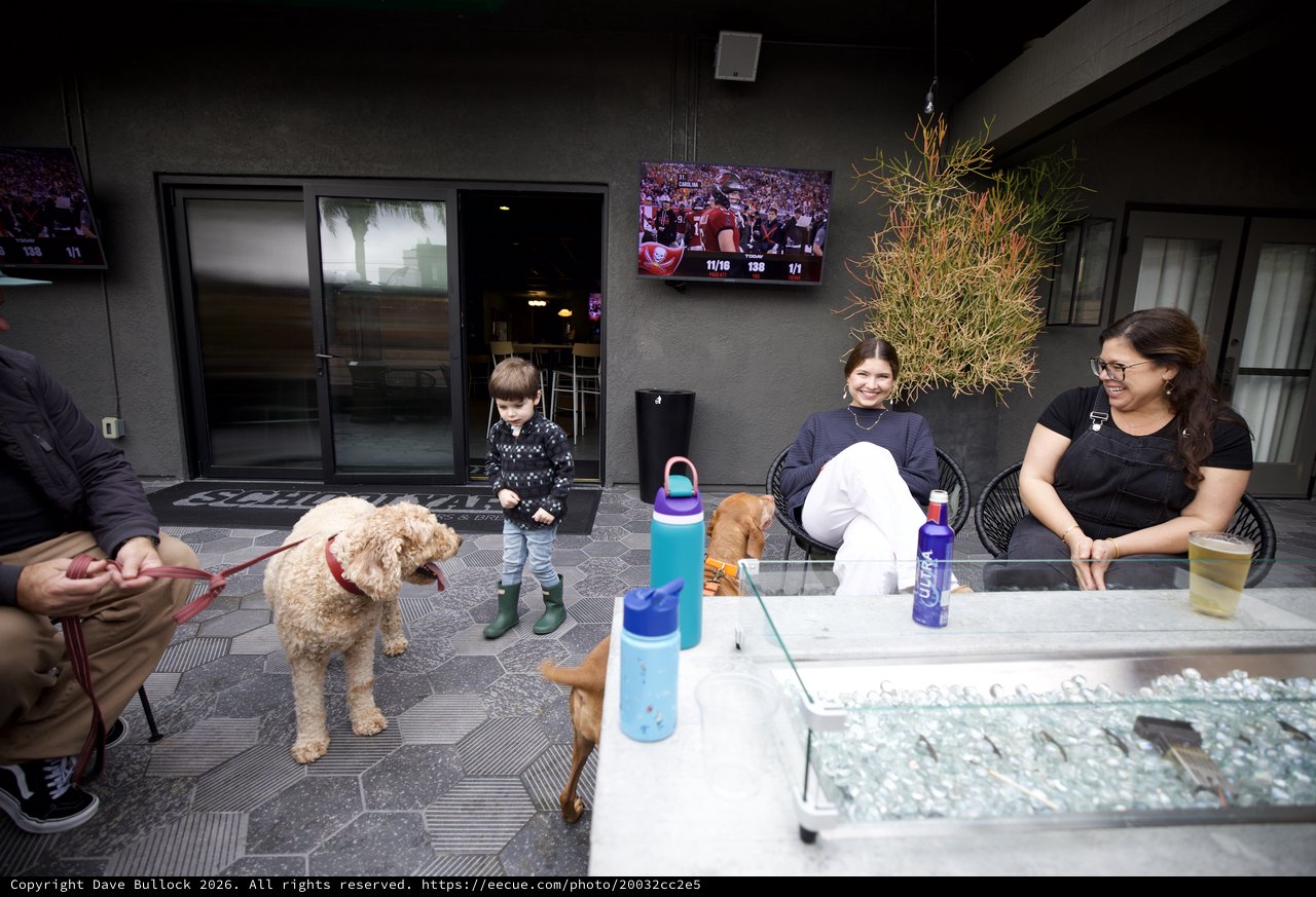 Family Gathering at Modern Outdoor Patio with Pet Dog