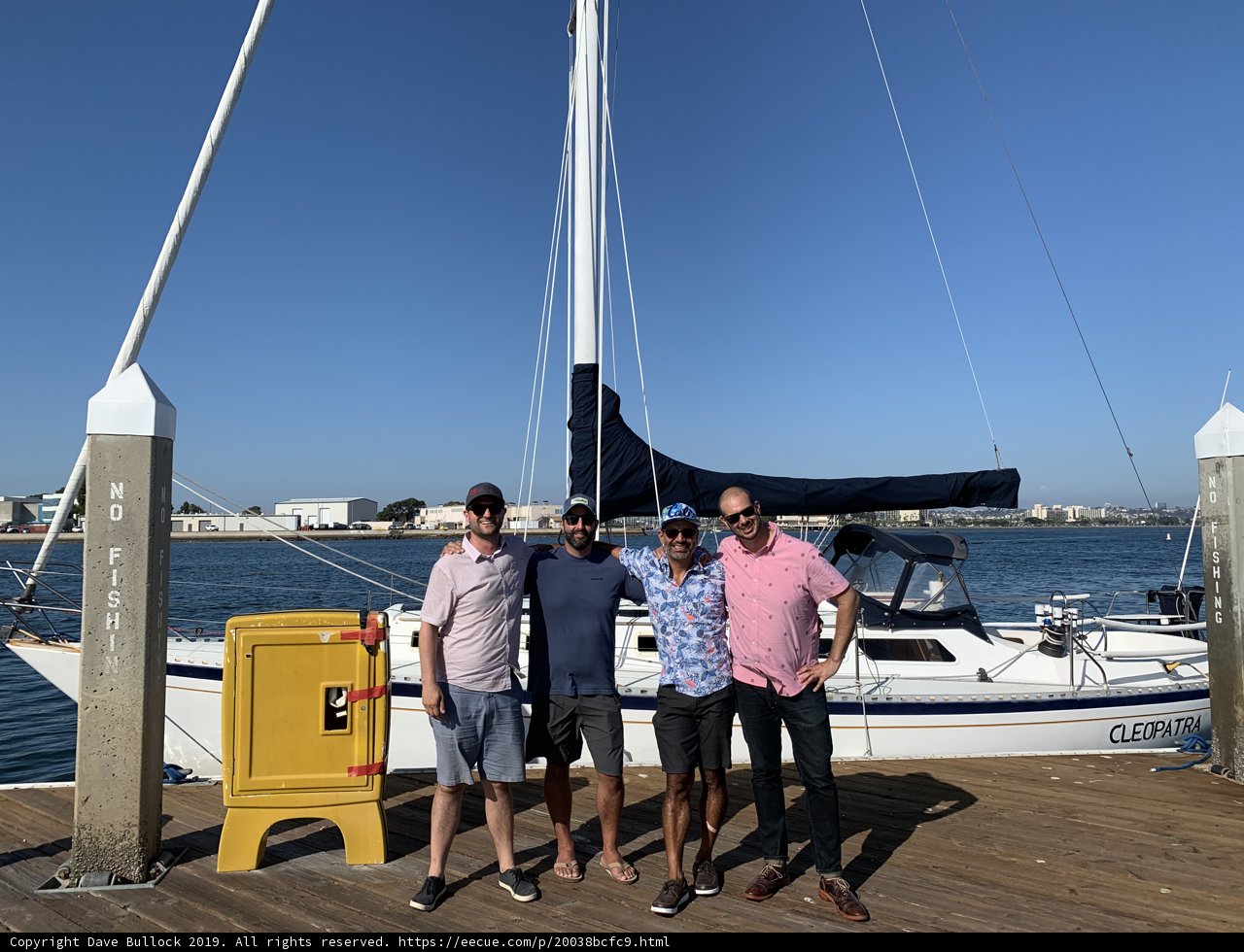 Four Men and their Sailboat at the Waterfront