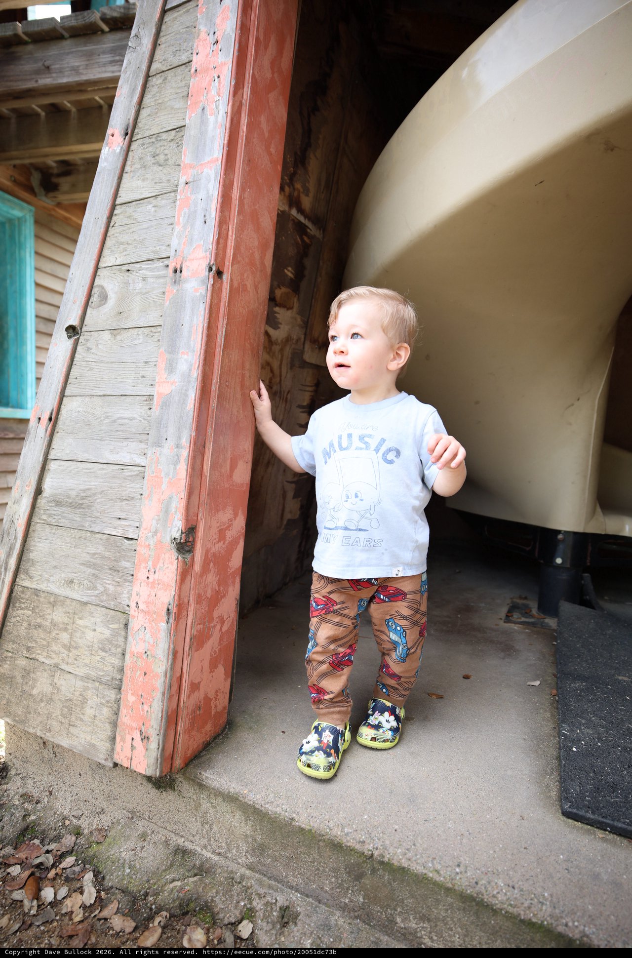 Young Boy Exploring Vintage Doorway with Curiosity
