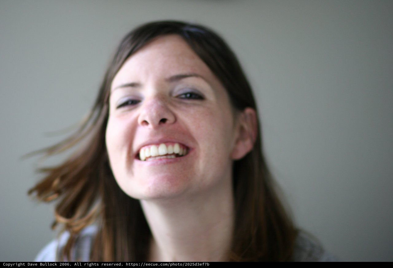 Joyful Woman Laughing with Hair in Motion