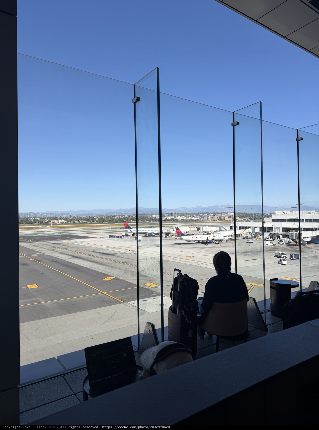 Silhouette Waiting at Airport Gate Overlooking Tarmac