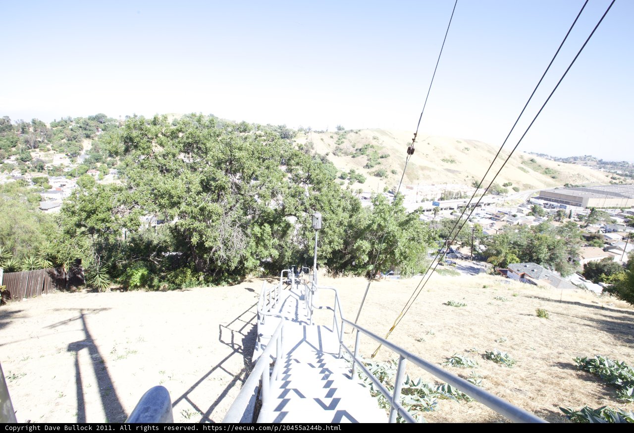 Cable Car Ascends Hill Against Blue Sky