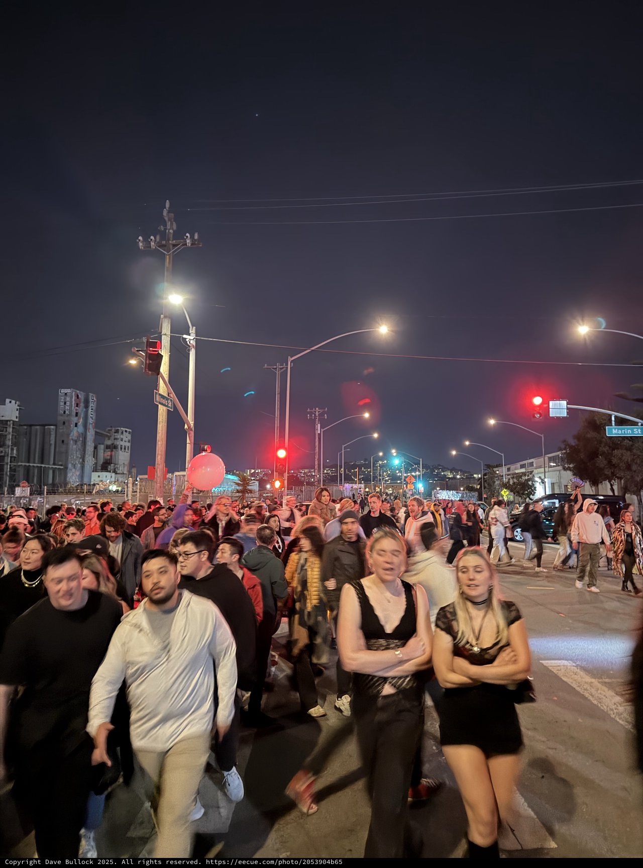 Night Crowd at Urban Street Intersection with Red Traffic Lights