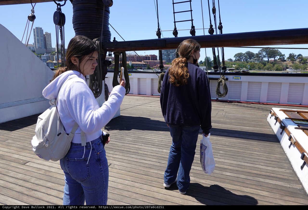 Tourists Exploring Historic Sailing Ship Deck
