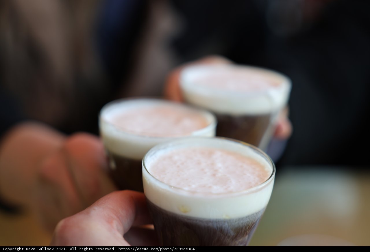 Three People Enjoying Their Drinks