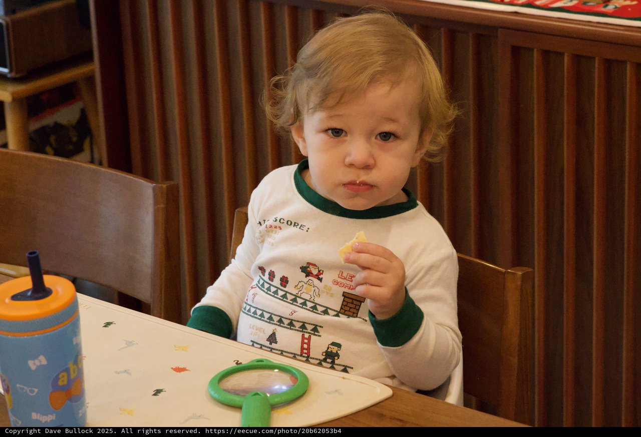 Toddler Enjoying Snack Time in Festive Gaming Shirt
