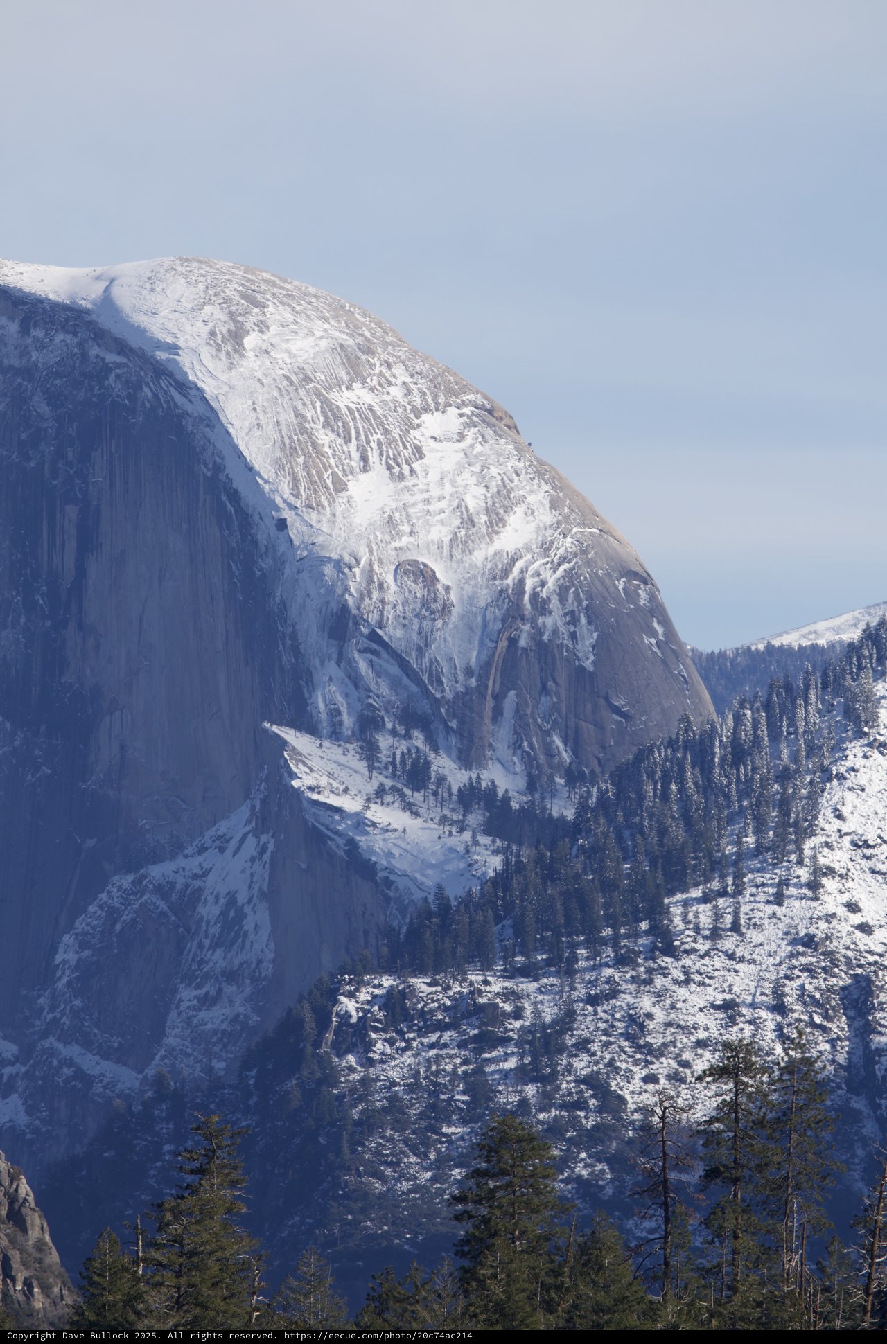Half Dome's Majestic Snow-Covered Granite Face in Winter