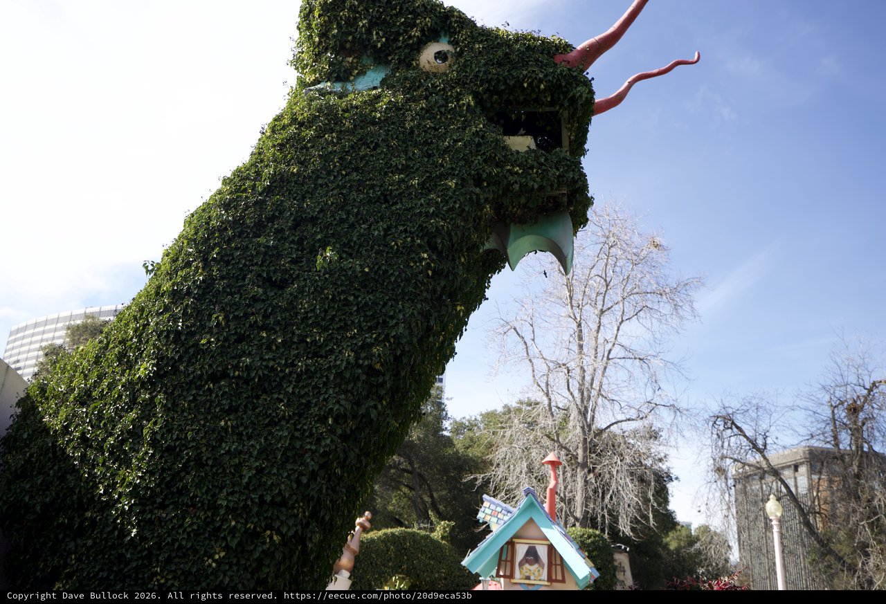 Ivy-Covered Dragon Topiary Looms Over Fantasyland