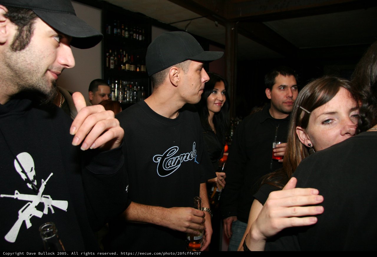 Friends Socializing at a Dimly Lit Nightclub Bar