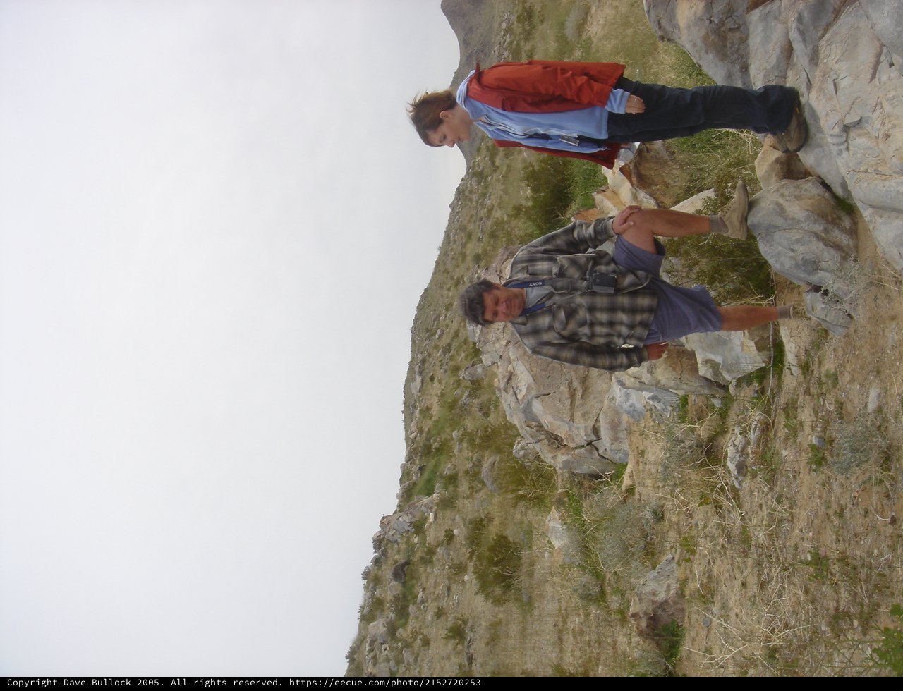 Father and Son Hiking Rocky Hillside Together