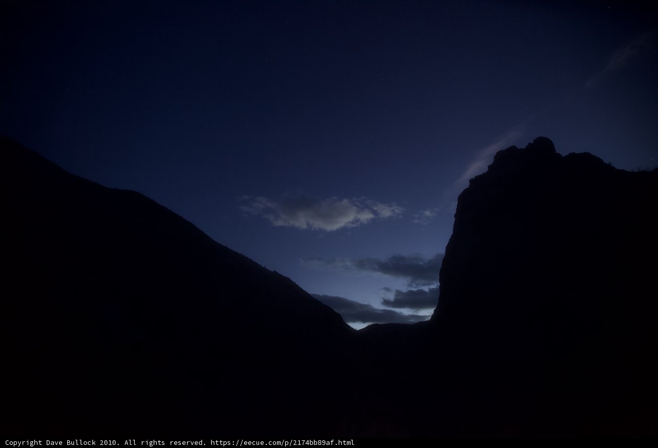 Majestic Mountain Silhouette under Dramatic Night Sky